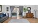 Inviting living room featuring sliding glass doors to the lanai, wood-look floors, and neutral decor at 8248 Marbella View Ct, Orlando, FL 32817