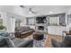 Inviting living room featuring a stone fireplace, built-in shelving, and comfortable seating area at 8248 Marbella View Ct, Orlando, FL 32817
