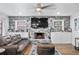 Cozy living room featuring a stone fireplace with built-in storage and a large flat-screen television at 8248 Marbella View Ct, Orlando, FL 32817