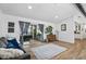 Bright living room showcasing wood flooring and sliding door to outside patio at 8248 Marbella View Ct, Orlando, FL 32817