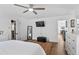 Bright main bedroom features wood-look flooring, a ceiling fan, and ensuite bathroom access at 8248 Marbella View Ct, Orlando, FL 32817