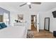 Light-filled main bedroom with wood-look floors, ensuite access, and ceiling fan at 8248 Marbella View Ct, Orlando, FL 32817