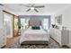 Stylishly decorated main bedroom featuring a large headboard, ceiling fan, and barn-style door at 8248 Marbella View Ct, Orlando, FL 32817