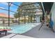 Home's beautiful screened pool area with deck, swing, and mature landscaping at 8248 Marbella View Ct, Orlando, FL 32817