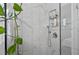 A clean shower showcases marble-like tile, a handheld sprayer, and convenient shelving for toiletries at 8248 Marbella View Ct, Orlando, FL 32817