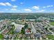Aerial view of home near John Young Parkway, community pool, and a tranquil lake at 826 Long Bay Ct, Kissimmee, FL 34741