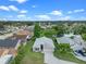 Aerial view of home showcasing its well-maintained landscaping, serene pond, and neighborhood at 826 Long Bay Ct, Kissimmee, FL 34741