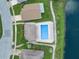 Overhead shot of a community pool with lounge chairs with a beautiful lake view at 826 Long Bay Ct, Kissimmee, FL 34741