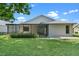 The backyard features a screened patio, a well-manicured lawn, and lush landscaping at 826 Long Bay Ct, Kissimmee, FL 34741