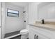 Modern bathroom featuring a black-trimmed window and black hardware in the shower and sink area at 826 Long Bay Ct, Kissimmee, FL 34741