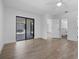 Bright bedroom featuring hardwood floors, ensuite bathroom, and sliding glass door to the backyard at 826 Long Bay Ct, Kissimmee, FL 34741