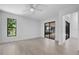 Bright bedroom featuring hardwood floors, a ceiling fan, and sliding glass door to a screened-in backyard at 826 Long Bay Ct, Kissimmee, FL 34741