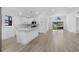 Clean, modern kitchen featuring white cabinets, a center island, and wood-look floors at 826 Long Bay Ct, Kissimmee, FL 34741