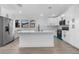 Modern kitchen featuring white cabinets, stainless steel appliances, and a large center island at 826 Long Bay Ct, Kissimmee, FL 34741