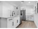 Bright kitchen featuring a center island, white cabinets, and stainless steel appliances at 826 Long Bay Ct, Kissimmee, FL 34741