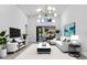 Bright living room featuring an elegant chandelier and seamless indoor-outdoor flow to a screened lanai at 826 Long Bay Ct, Kissimmee, FL 34741