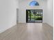 Spacious and bright living area featuring hardwood floors and sliding glass doors to the backyard at 826 Long Bay Ct, Kissimmee, FL 34741