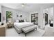Relaxing bedroom with a ceiling fan, large windows, and glass door to the screened-in patio with seating at 826 Long Bay Ct, Kissimmee, FL 34741