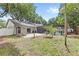 Backyard features fire pit, brick patio, and screened-in pool area at 8308 Granada Blvd, Orlando, FL 32836