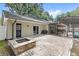 Backyard features fire pit, brick patio, and screened-in pool area at 8308 Granada Blvd, Orlando, FL 32836