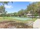 Community basketball court with shade, a covered picnic area and a lake in the background at 8308 Granada Blvd, Orlando, FL 32836