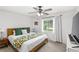Cozy bedroom featuring carpet, a ceiling fan, and a window with natural light at 8308 Granada Blvd, Orlando, FL 32836