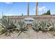 Welcoming entrance sign for Bay Lakes at Granada, surrounded by agave plants and a brick wall at 8308 Granada Blvd, Orlando, FL 32836