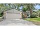 Home featuring a stone-accented facade, attached garage, and well-maintained landscaping enhancing curb appeal at 8308 Granada Blvd, Orlando, FL 32836