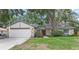 Charming single-story home featuring stone accents, a well-manicured lawn, and a two-car garage at 8308 Granada Blvd, Orlando, FL 32836