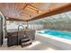 Hot tub in screened patio with wooden roof, easy access to the in-ground pool at 8308 Granada Blvd, Orlando, FL 32836