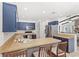 Well-appointed kitchen with blue cabinets and a breakfast bar, perfect for casual dining at 8308 Granada Blvd, Orlando, FL 32836