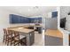 Kitchen featuring blue cabinets, stainless steel appliances, tile flooring, and breakfast bar with seating at 8308 Granada Blvd, Orlando, FL 32836