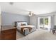 Spacious main bedroom with neutral carpet, ceiling fan, and sliding glass doors to the outside at 8308 Granada Blvd, Orlando, FL 32836