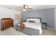 Main bedroom with neutral carpet, blue accent wall, and wooden dresser at 8308 Granada Blvd, Orlando, FL 32836