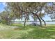 Community playground with mature trees providing shade and a lake with dock in the background at 8308 Granada Blvd, Orlando, FL 32836
