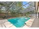 In-ground pool surrounded by screened enclosure, lush greenery, and lounge furniture at 8308 Granada Blvd, Orlando, FL 32836