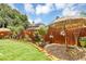 Serene backyard with vibrant lawn, decorative fence, and charming landscaping details at 887 Reedy Cv, Casselberry, FL 32707