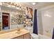 Nautical themed bathroom features a shower over tub and a vanity with marble countertop at 887 Reedy Cv, Casselberry, FL 32707