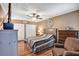 Comfortable bedroom featuring a ceiling fan, hardwood floors, and a neutral color scheme at 887 Reedy Cv, Casselberry, FL 32707