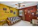This colorful bedroom is decorated with framed art and includes a sofa and ceiling fan at 887 Reedy Cv, Casselberry, FL 32707