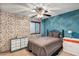 Stylish bedroom with two-tone wallpaper, natural light, and updated furnishings at 887 Reedy Cv, Casselberry, FL 32707