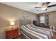 Comfortable bedroom with hardwood floors, ceiling fan, and neutral wall color at 887 Reedy Cv, Casselberry, FL 32707