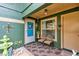 Inviting front porch with seating area featuring decorative chairs and a welcome mat at 887 Reedy Cv, Casselberry, FL 32707