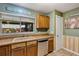 Practical kitchen with laminate countertops, wooden cabinets, and stainless steel dishwasher at 887 Reedy Cv, Casselberry, FL 32707