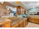 Well-lit kitchen with laminate countertops, wooden cabinets, and modern appliances at 887 Reedy Cv, Casselberry, FL 32707