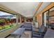 Enclosed lanai with cozy seating, carpeted floor, and a bright, inviting outdoor view at 887 Reedy Cv, Casselberry, FL 32707