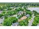 An aerial captures a community dotted with pools and backing onto a tranquil lake at 991 Hawthorne Cove Ct, Ocoee, FL 34761