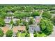 A high altitude aerial view of the neighborhood homes surrounded by dense trees at 991 Hawthorne Cove Ct, Ocoee, FL 34761