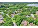 Bird's-eye view of an idyllic suburban neighborhood with tree-lined streets and a scenic lake at 991 Hawthorne Cove Ct, Ocoee, FL 34761