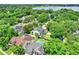 Aerial view of neighborhood with lake in the background, lush trees, and houses at 991 Hawthorne Cove Ct, Ocoee, FL 34761